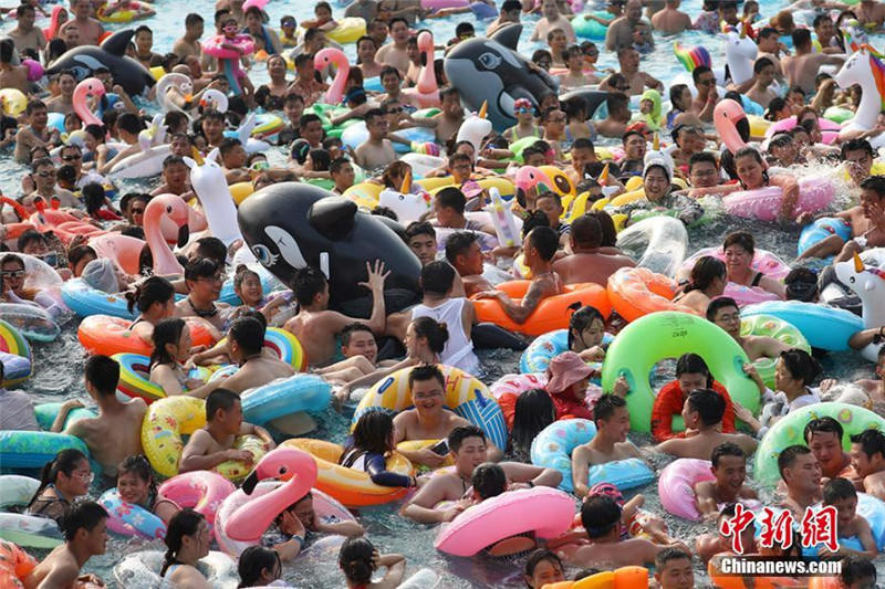 Жители города Нанкин купаются в воде для защиты от жары