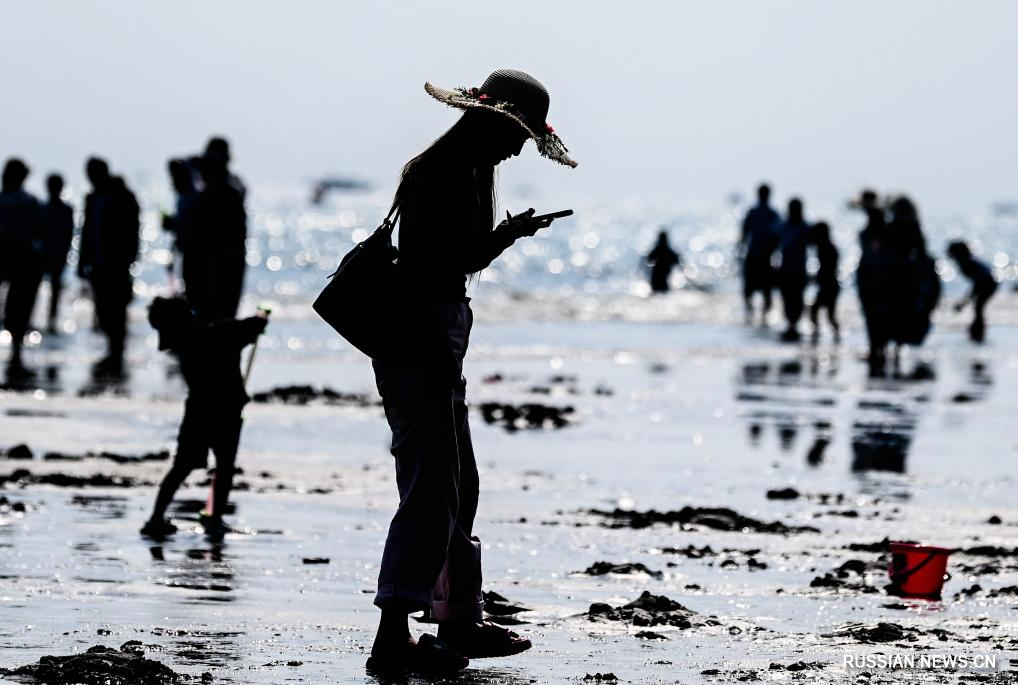 Туристический бум во время каникул по случаю праздника Весны на "золотом пляже" на юге Китая